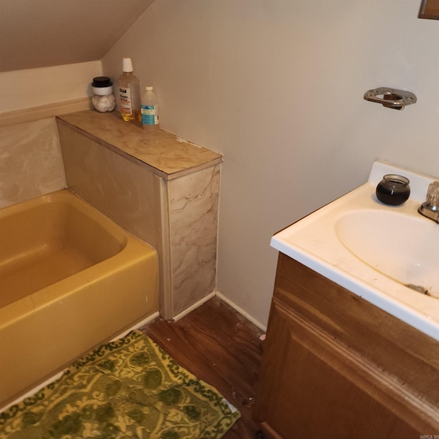 bathroom featuring a bathtub, vanity, and hardwood / wood-style flooring