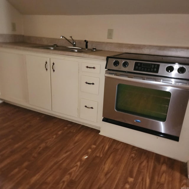 kitchen with white cabinetry, range, sink, and dark wood-type flooring