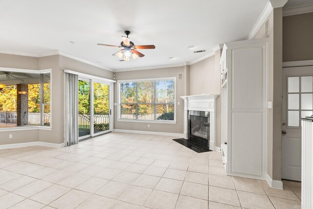 unfurnished living room with ceiling fan, light tile patterned flooring, a premium fireplace, and ornamental molding