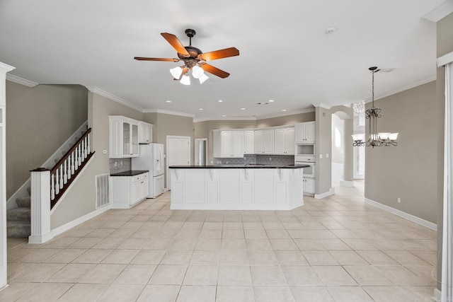 kitchen with white appliances, white cabinetry, ornamental molding, and tasteful backsplash