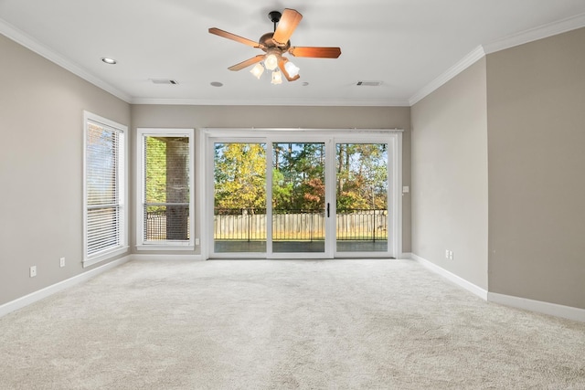 empty room featuring ceiling fan, ornamental molding, and carpet floors