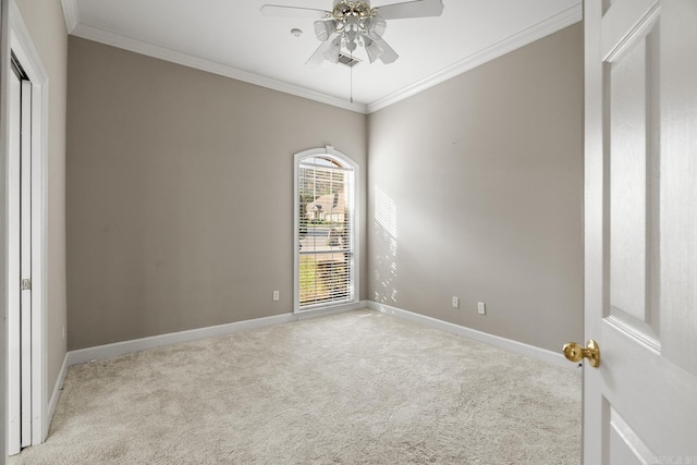 unfurnished room with light colored carpet, ceiling fan, and ornamental molding