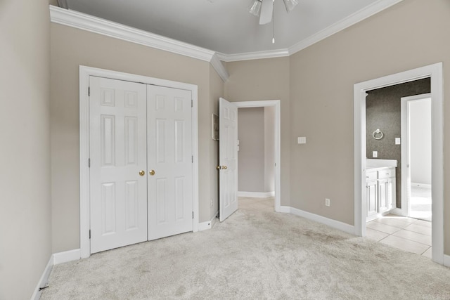 unfurnished bedroom with ceiling fan, crown molding, light carpet, and a closet