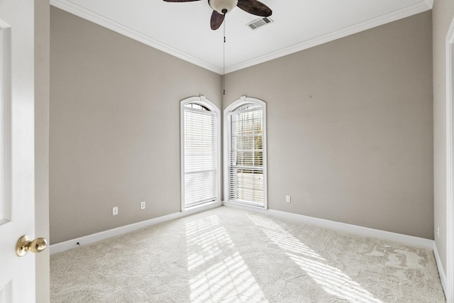 empty room featuring carpet, ceiling fan, and crown molding