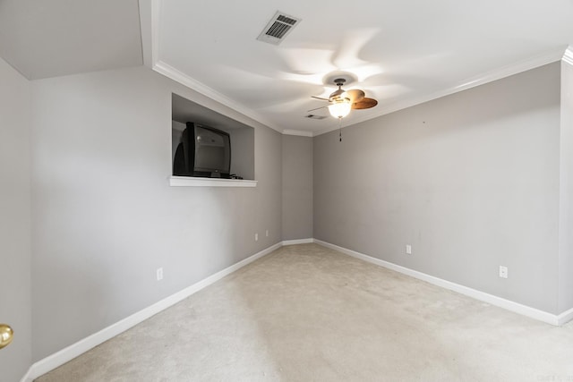 carpeted empty room with ceiling fan, crown molding, and vaulted ceiling