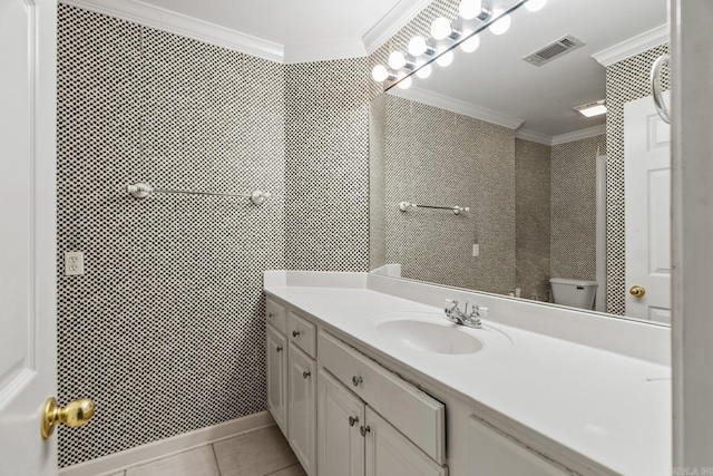 bathroom featuring toilet, vanity, tile patterned floors, and crown molding