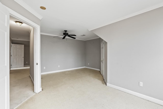 unfurnished room featuring ceiling fan, crown molding, and light carpet