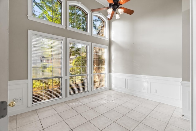 unfurnished sunroom featuring ceiling fan