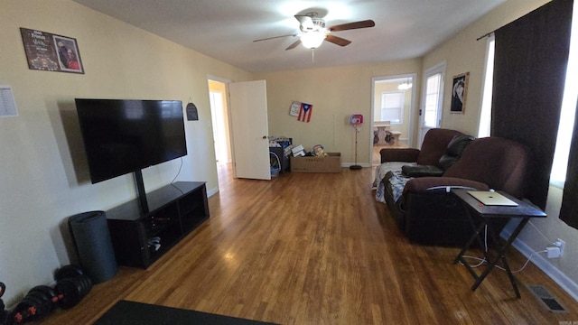 living room featuring hardwood / wood-style floors and ceiling fan