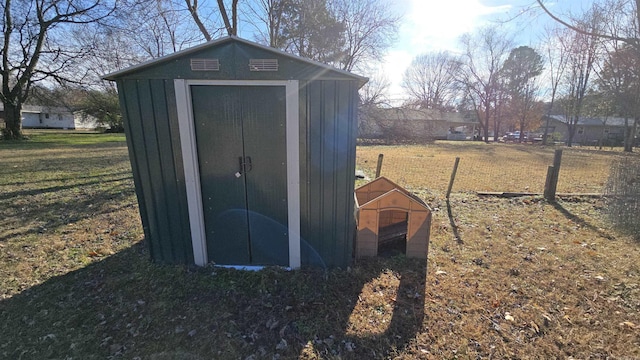 view of outdoor structure featuring a lawn