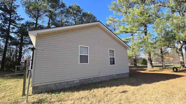 view of home's exterior with a lawn