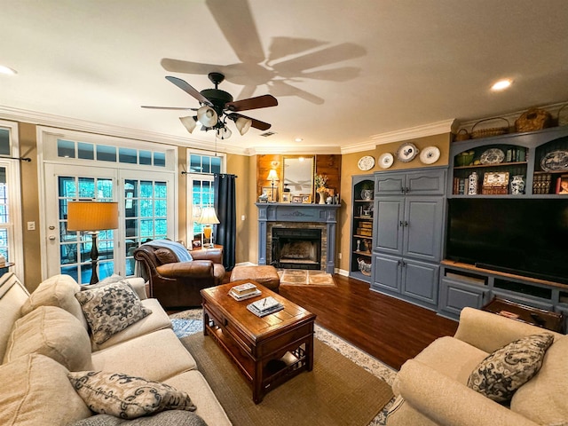 living room with crown molding, hardwood / wood-style floors, and ceiling fan