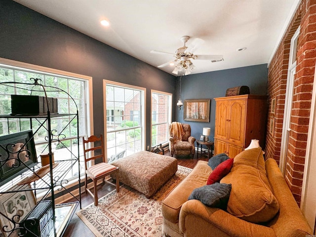 interior space featuring a fireplace, hardwood / wood-style floors, and ceiling fan