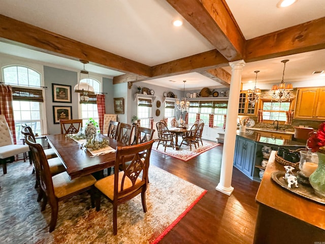 dining area with dark hardwood / wood-style flooring, ornate columns, sink, a notable chandelier, and beamed ceiling