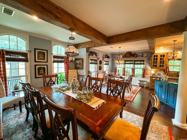 dining area with crown molding, dark wood-type flooring, and a notable chandelier