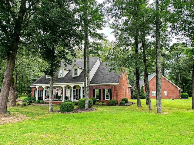 cape cod-style house with a porch and a front lawn