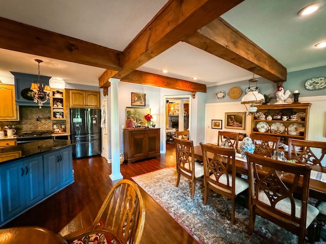 dining area with a notable chandelier, dark hardwood / wood-style floors, ornate columns, and beamed ceiling