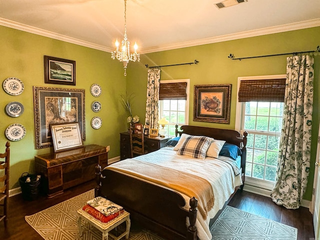 bedroom with multiple windows, a chandelier, dark hardwood / wood-style floors, and ornamental molding