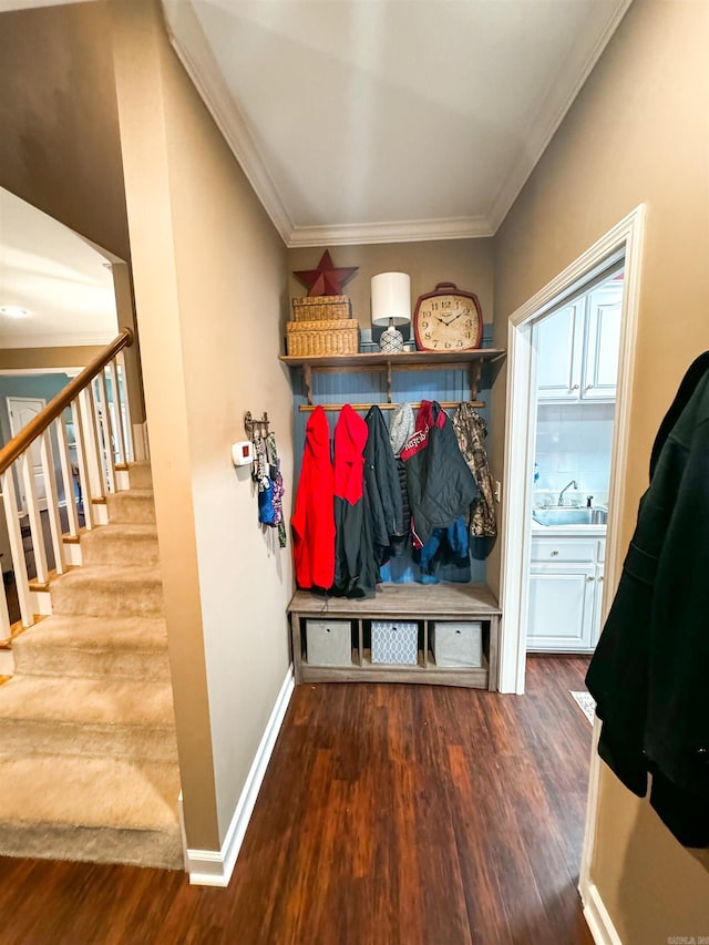 mudroom featuring wood-type flooring, sink, and ornamental molding