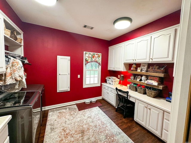 office featuring washer and clothes dryer, built in desk, and dark hardwood / wood-style floors