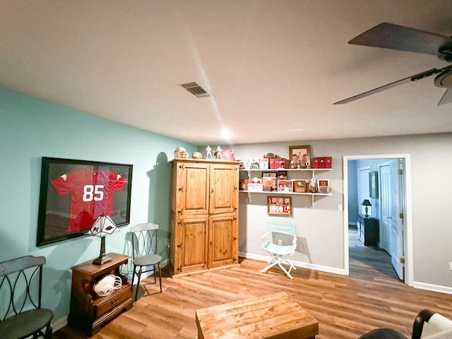 sitting room with ceiling fan and light hardwood / wood-style floors