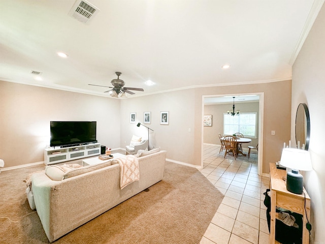 living room with light tile patterned floors, ceiling fan with notable chandelier, and ornamental molding