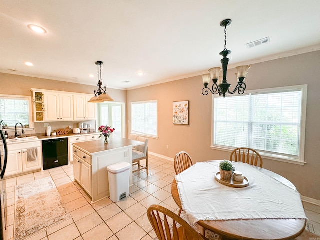 kitchen featuring sink, pendant lighting, a chandelier, black dishwasher, and a kitchen island