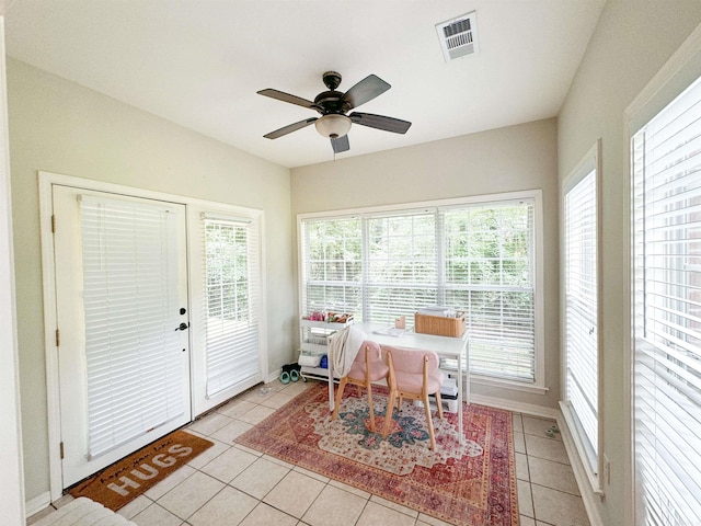 tiled office space featuring ceiling fan and plenty of natural light