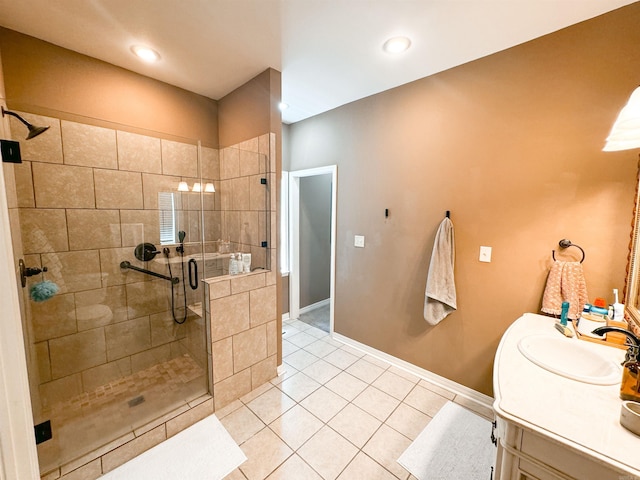 bathroom featuring tile patterned flooring, vanity, and walk in shower