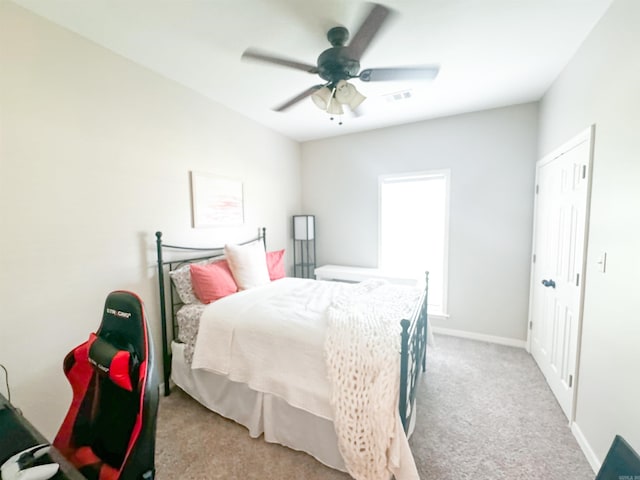 carpeted bedroom featuring a closet and ceiling fan