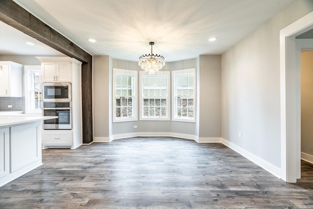 interior space featuring a chandelier and dark wood-type flooring