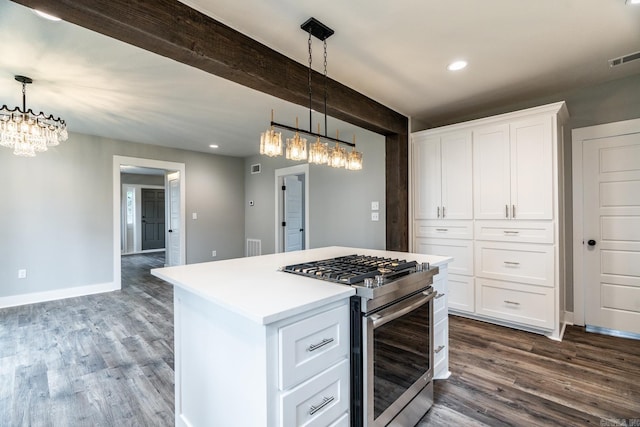 kitchen with white cabinets, a center island, pendant lighting, and stainless steel range with gas stovetop