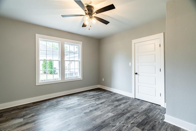 unfurnished room with ceiling fan and dark hardwood / wood-style flooring