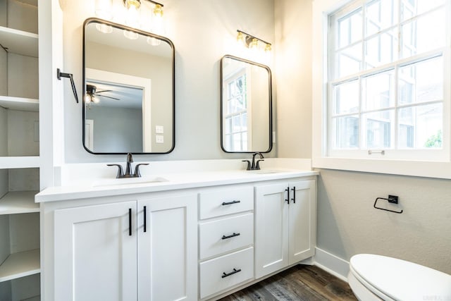 bathroom with hardwood / wood-style floors, ceiling fan, toilet, and vanity