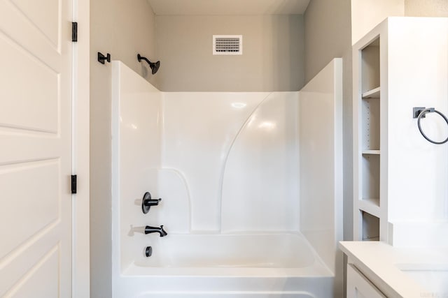 bathroom with vanity and  shower combination