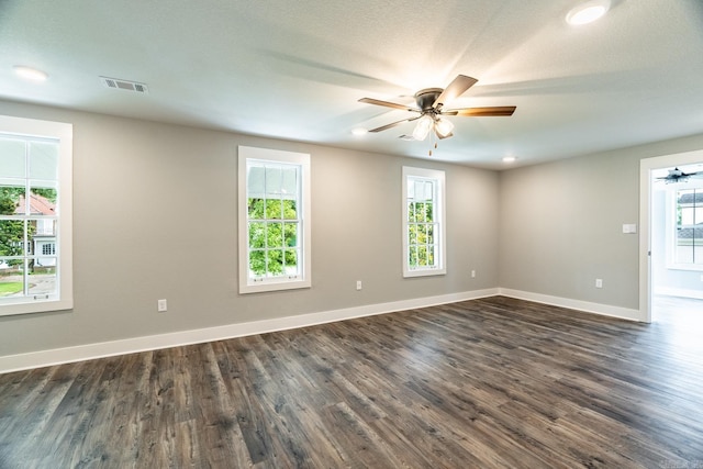 empty room with dark hardwood / wood-style floors and ceiling fan