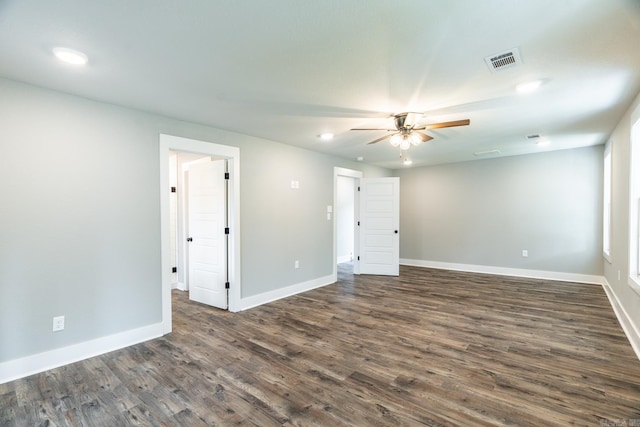 empty room with dark hardwood / wood-style floors and ceiling fan