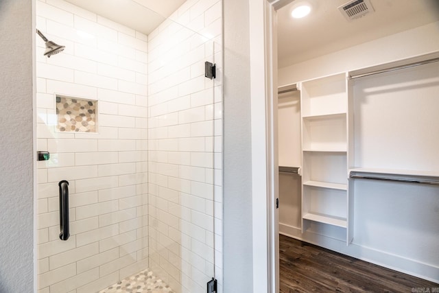 bathroom with hardwood / wood-style floors and an enclosed shower