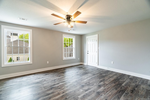 spare room with ceiling fan and dark hardwood / wood-style floors