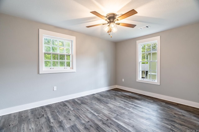 empty room with ceiling fan and dark wood-type flooring