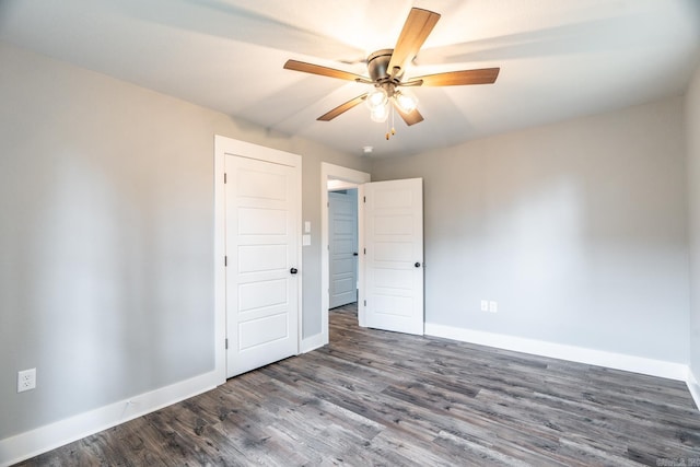 unfurnished room featuring dark hardwood / wood-style floors and ceiling fan