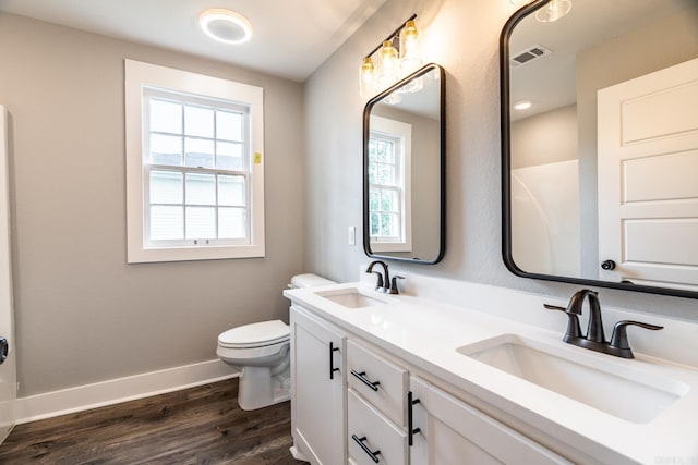 bathroom with toilet, vanity, and hardwood / wood-style flooring