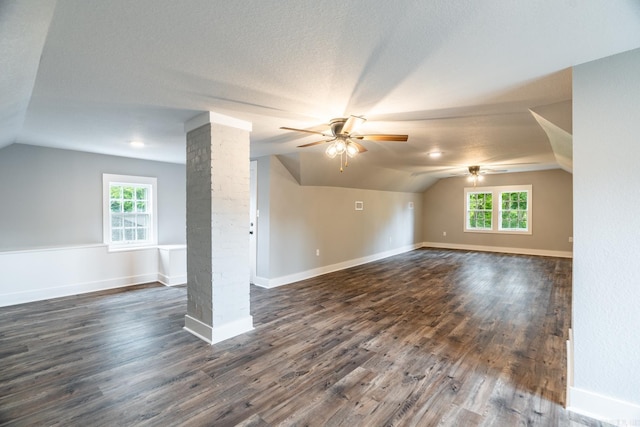 additional living space with ceiling fan, dark wood-type flooring, and vaulted ceiling