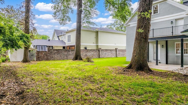 view of yard featuring a patio area and a balcony