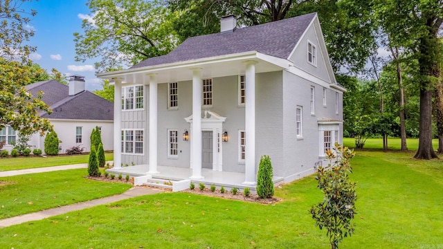 view of front of house featuring covered porch and a front yard