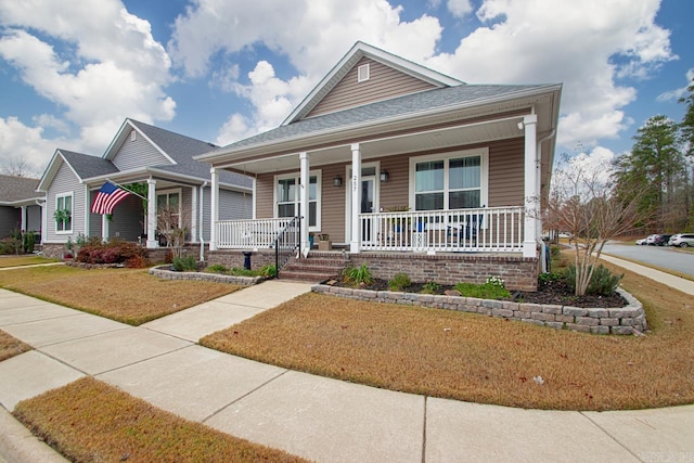 view of front facade with a porch and a front lawn