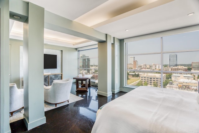 bedroom featuring a fireplace and a wall of windows