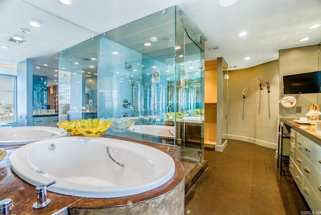 bathroom with vanity and shower with separate bathtub