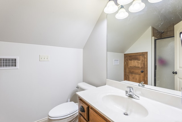 bathroom with a shower with shower door, toilet, lofted ceiling, and vanity