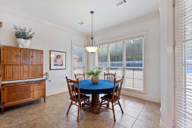 dining room with ornamental molding and light tile patterned flooring